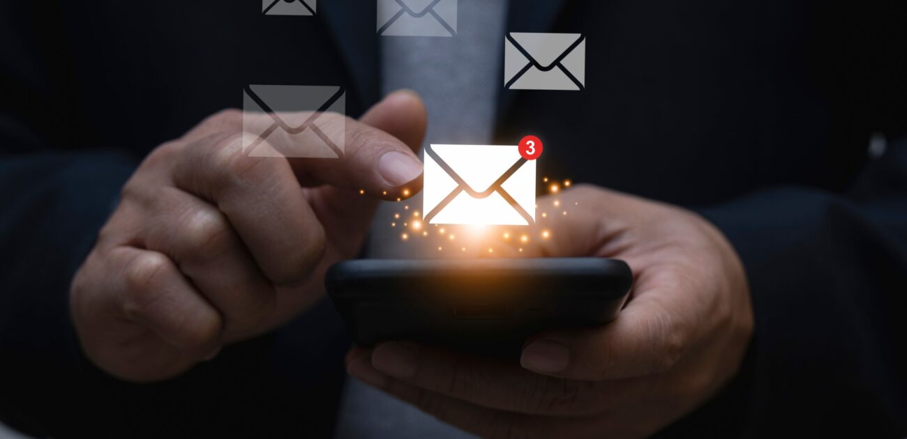 A man presses a mail icon on his smartphone