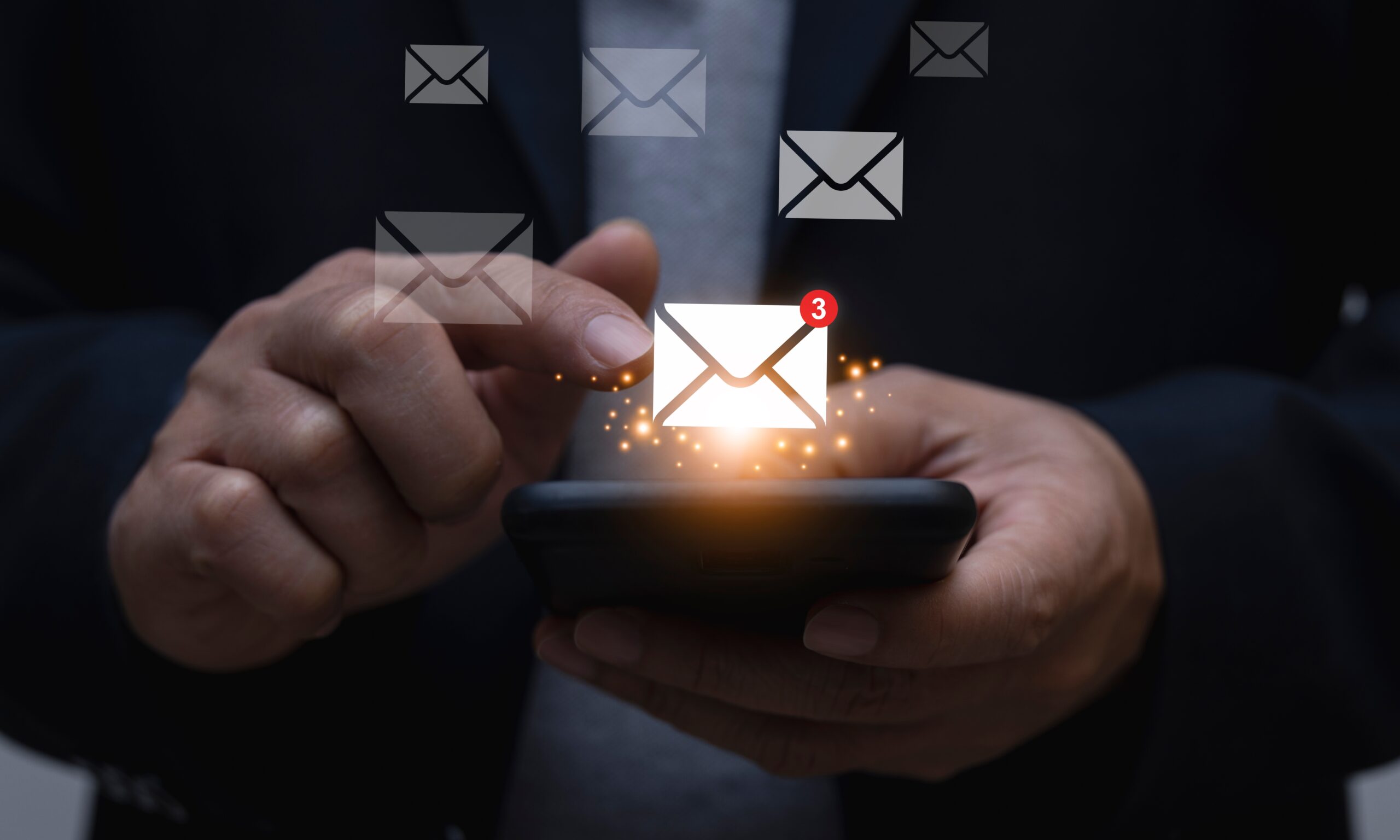 A man presses a mail icon on his smartphone