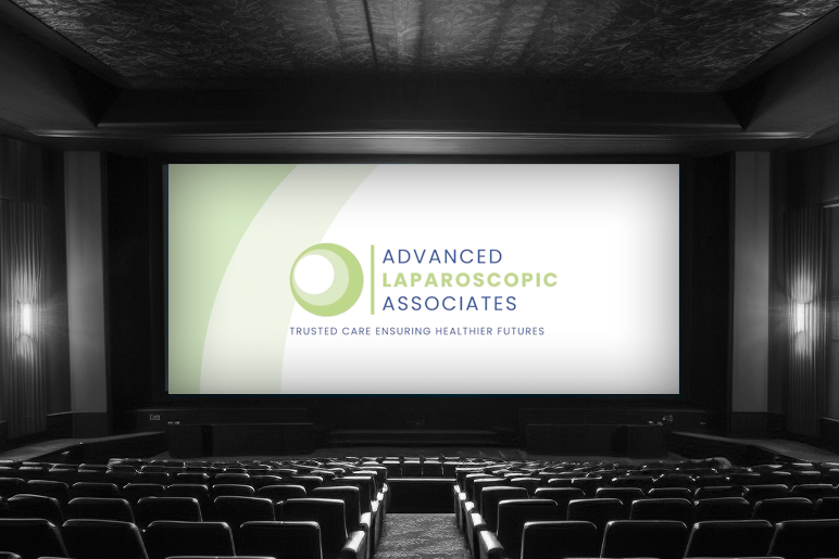 An advertisement is shown on a movie theater screen in an empty theaters