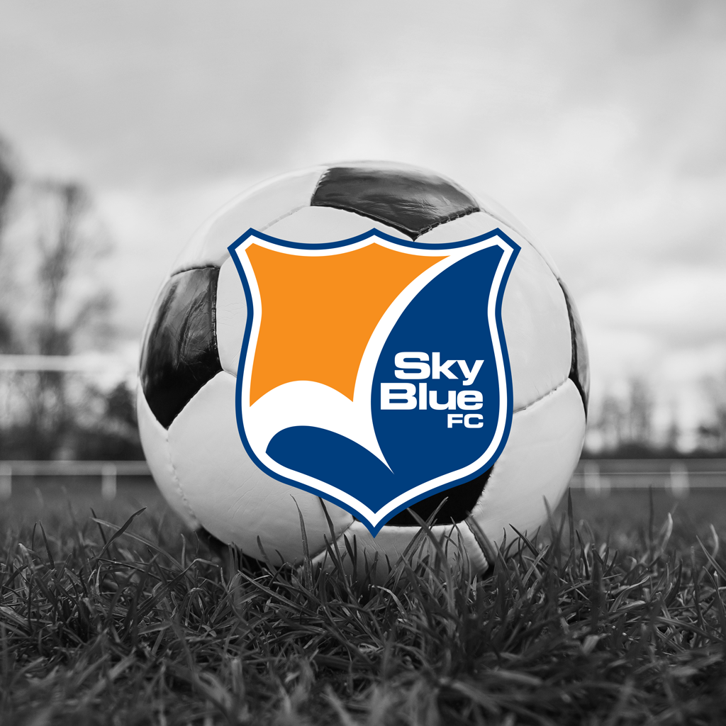 A soccer ball on a field with the logo for Sky Blue FC imposed on top of it